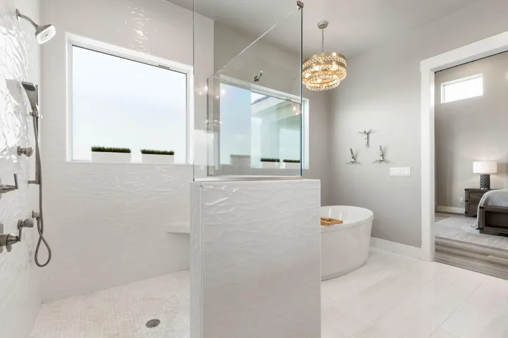 Indulge in a true spa experience with elegant designer tilework, a soaking tub, and multiple shower heads crafted for pure everyday indulgence.