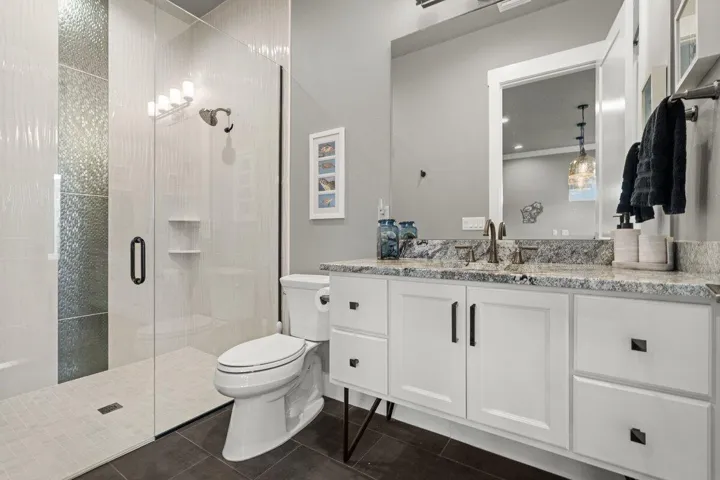 Stylish and beautifully finished, this first-floor guest bath offers sleek designer touches and a walk-in shower that makes everyday living feel effortlessly luxurious.