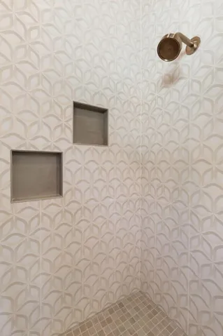 Intricate designer tilework transforms this walk-in shower into a true statement piece, blending texture, pattern, and luxury into a space that feels straight out of a boutique resort.