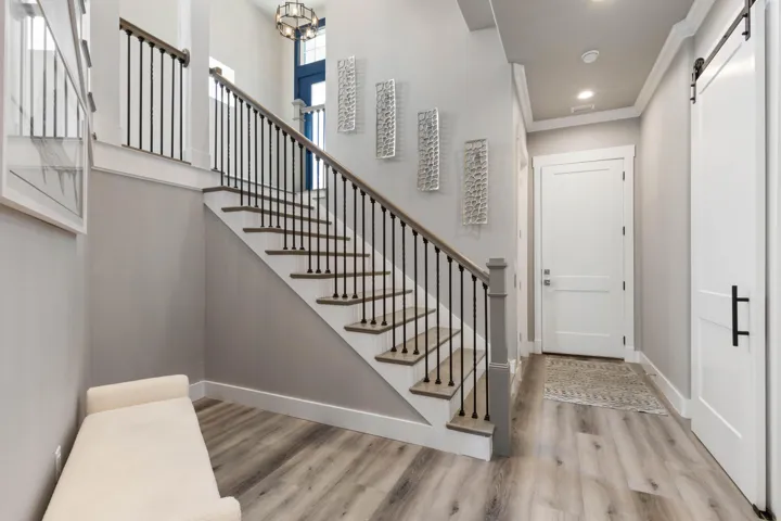 From the moment you step inside, the striking staircase and soaring entry create a sense of arrival that feels both grand and welcoming.