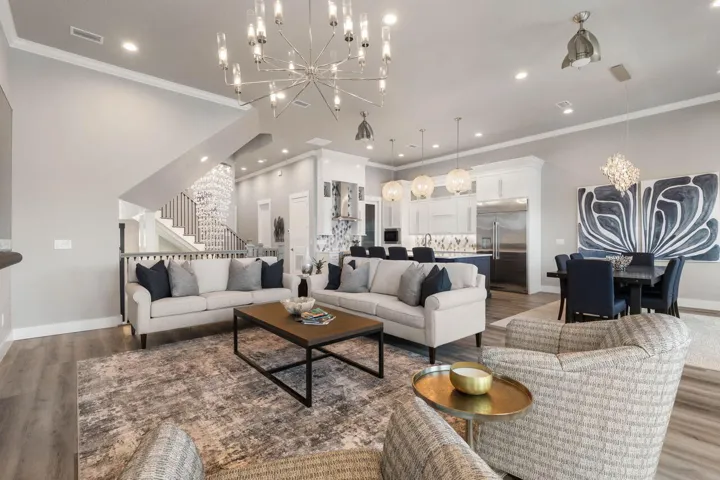 The expansive open living area shines with incredible designer lighting, creating a warm yet dramatic atmosphere perfect for both relaxed living and stylish entertaining.