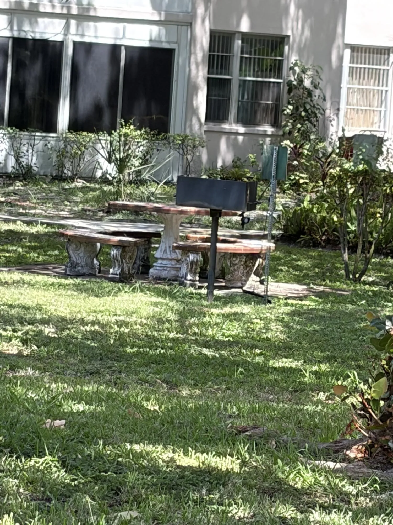 Courtyard, patio table and grill.