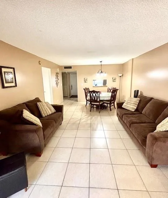 Living room toward dining area. Furniture included.