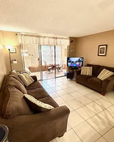 Living room toward patio. Furniture included.