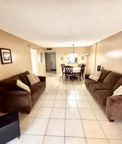 Living room toward dining area. Furniture included.