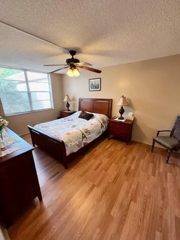 Master bedroom with laminate flooring. Furniture included.