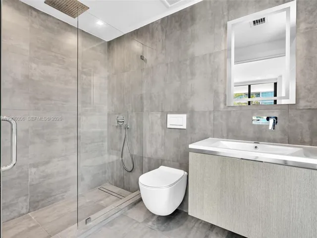 Bath with glass shower.