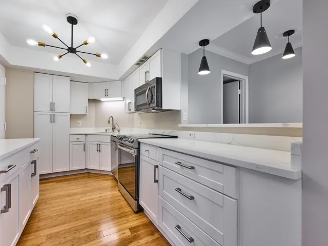 The fully renovated kitchen features quartz counters, stainless appliances, new lighting and plenty of workspace and storage.