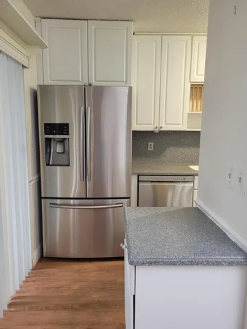 All newer appliances with side by side refrigerator stainless steel look, Newer dishwasher and Corian counter tops.