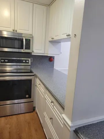 showing the pass through as well as cabinets top and bottom. Well over 13 cabinets just in kitchen alone.