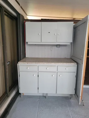 On the West side of the porch is a large shed that was built sometime ago. Great for hobbiest as well as the weekend warrior. lots of cabinet space as well as a locked shed area as well. See other photos for interior.