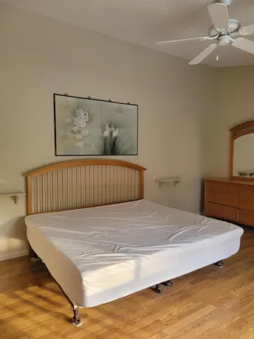 Beautiful well kept laminate flooring on second floor Master bedroom, note the vaulted ceiling over bed