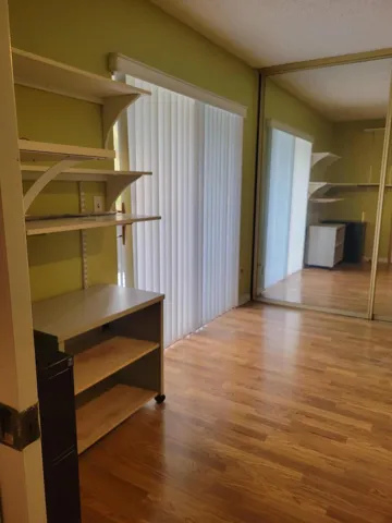 This room was used as a home office, but is ready to go as a large 12.2 by 12 second master if a door is added to bathroom. Huge Floor to ceiling closets with mirrored fronts over 12 feet of storage.