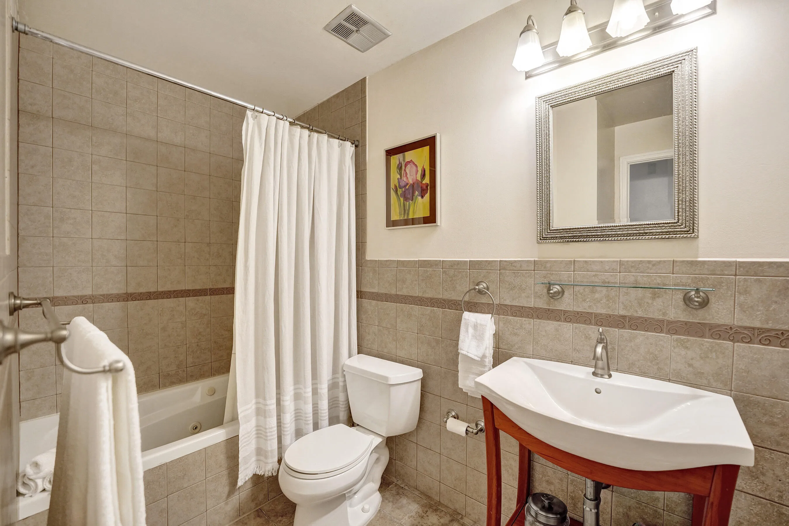 Updated Secondary Full Bathroom with Tile Surround.