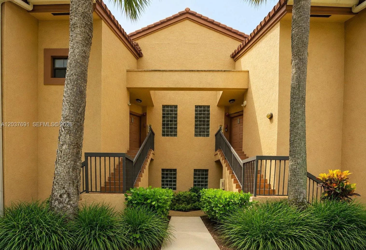 Private exterior staircase leads directly to this top-floor corner residence, offering added privacy, no neighbors above and a single-family-home feel