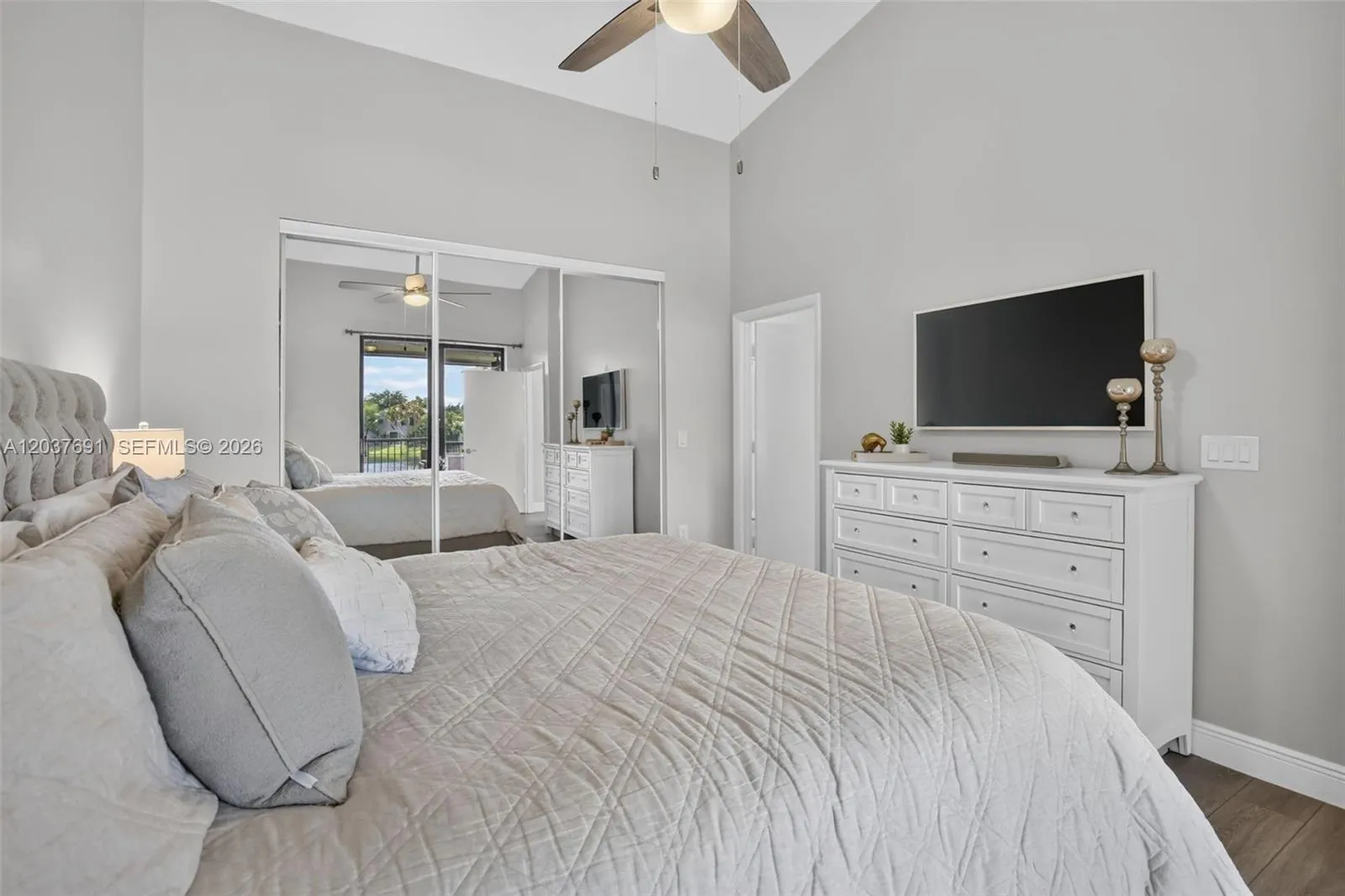 Wake up to peaceful water views from this spacious primary suite with balcony access and abundant natural light