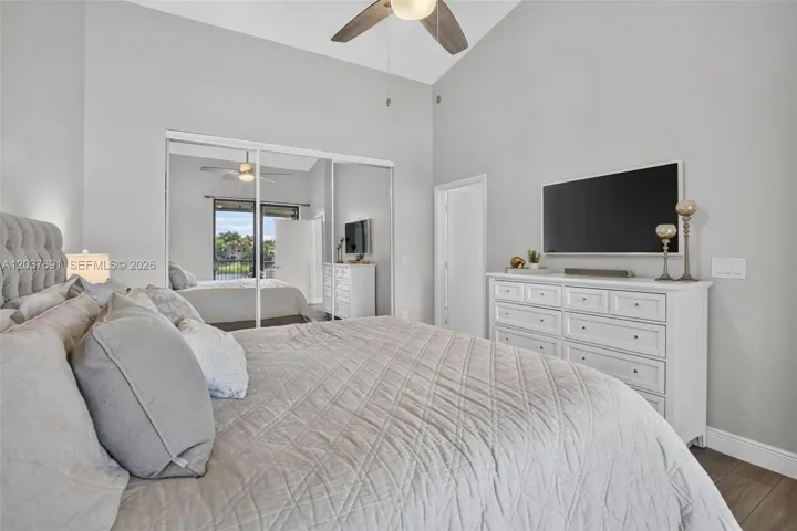 Wake up to peaceful water views from this spacious primary suite with balcony access and abundant natural light