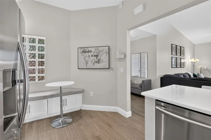 A custom built-in breakfast nook with integrated storage creates the perfect spot for morning coffee, casual meals or catching up on emails while maximizing both function and style