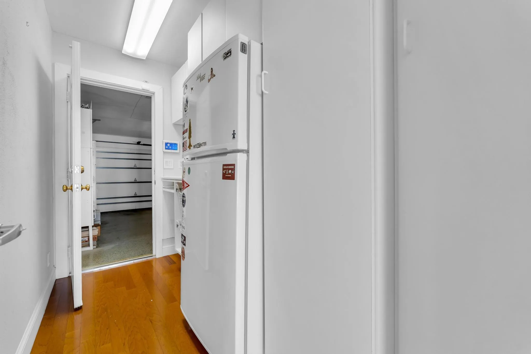 2nd fridge in hallway to garage with extra storage