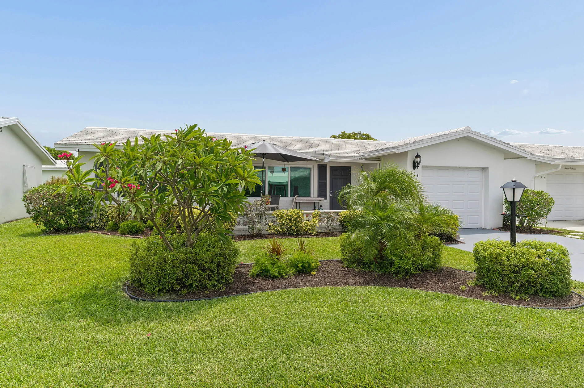 Lushy landscaped home with double concrete drive.