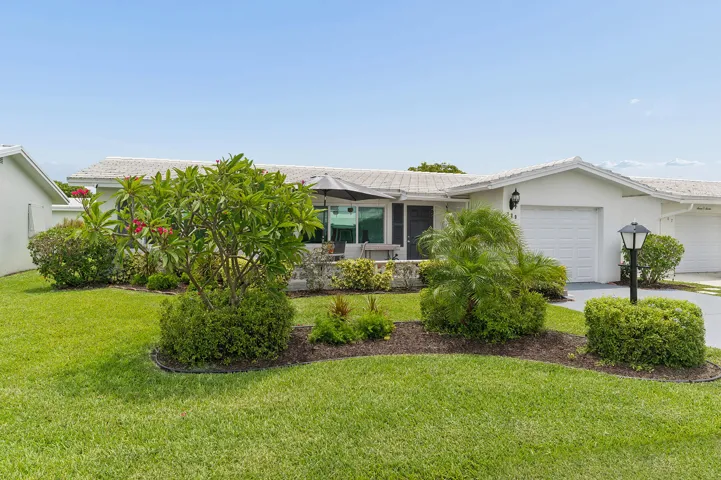 Lushy landscaped home with double concrete drive.