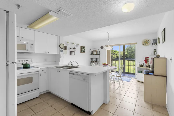 Spacious all-white kitchen in pristine condition