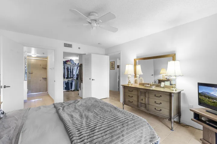 Primary bedroom with on suite bathroom and walk in closet - also sliders to covered/ screened patio