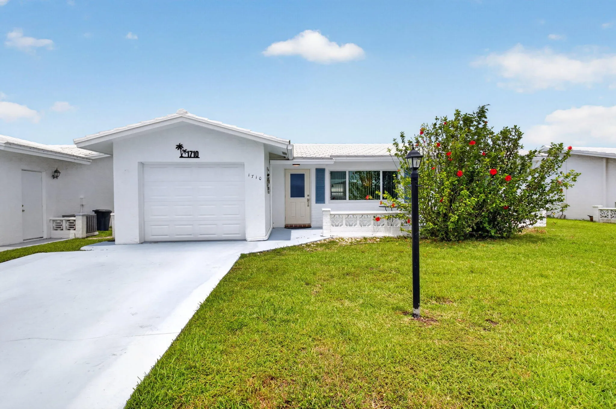 Driveway, garage, front entry, and front lanai