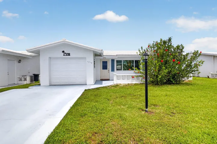 Driveway, garage, front entry, and front lanai