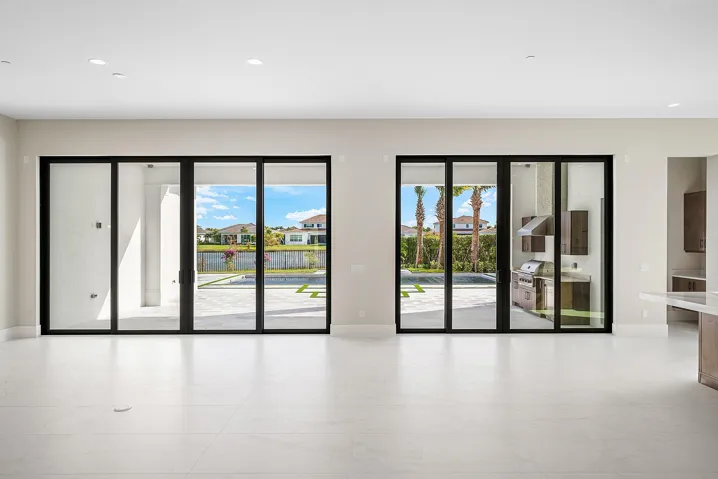 10' Sliding Glass Doors lead to large covered Lanai with Built-in Summer Kitchen. {NOTE: Lot 89 Photo for Reference Only}