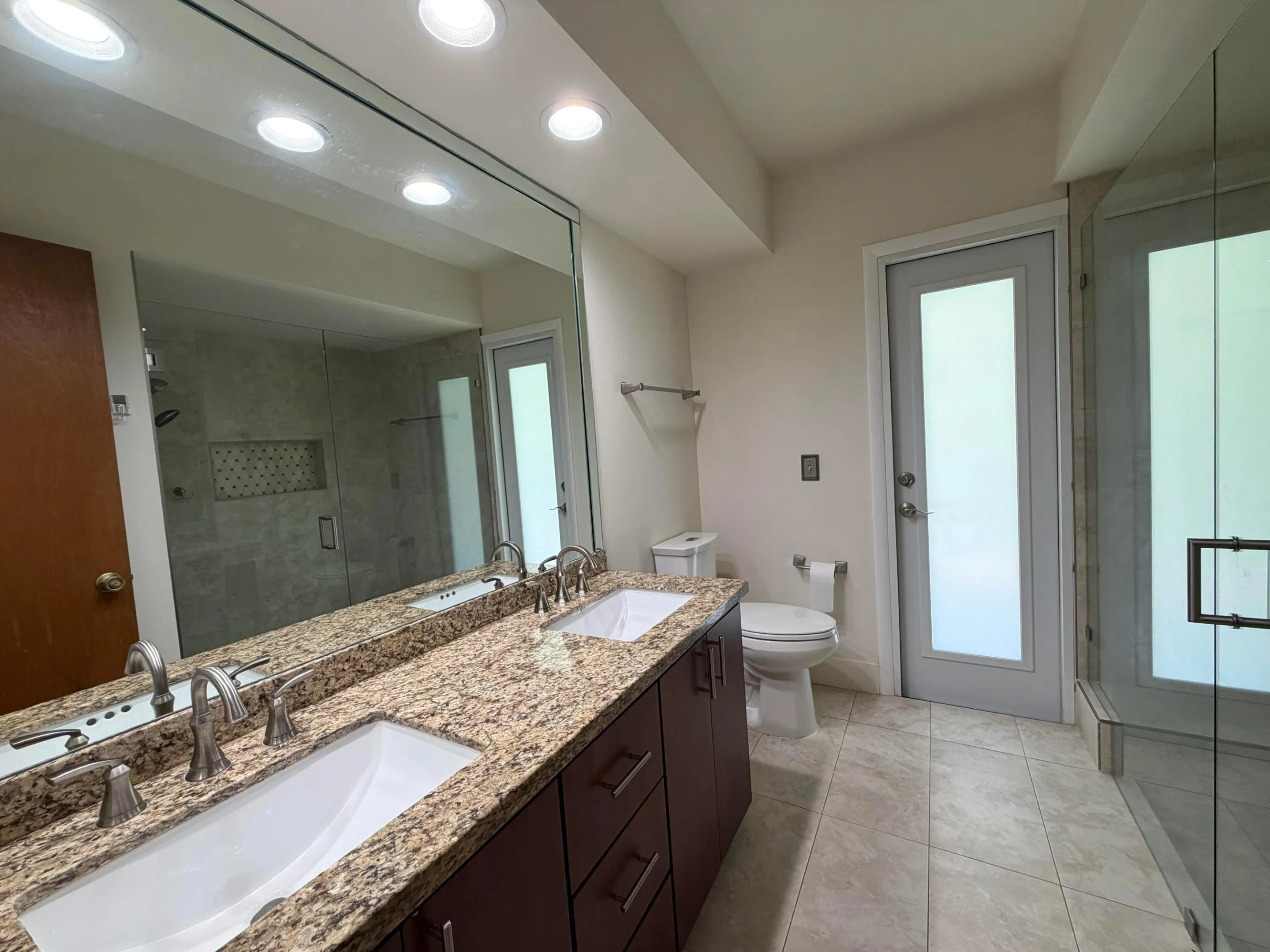 Primary on-suite bathroom with double sinks and Cabana Pool Patio Door