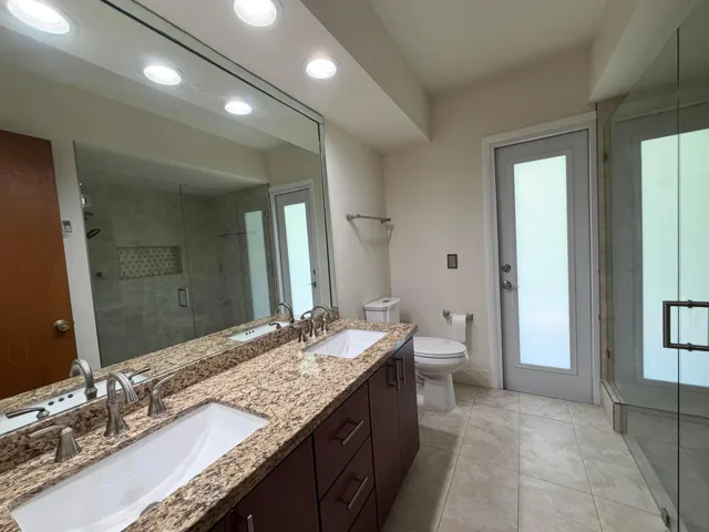 Primary on-suite bathroom with double sinks and Cabana Pool Patio Door