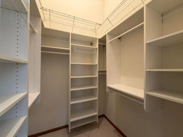 Walk-in Closet in Primary Bedroom (built-in floor safe not pictured)