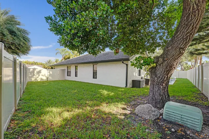 Additional grassy side yard with shady tree