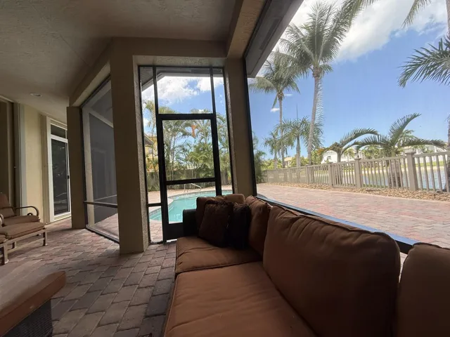 Covered outdoor living overlooking pool