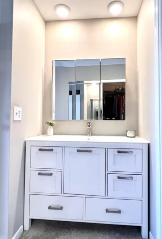 Primary bathrom has a step in shower