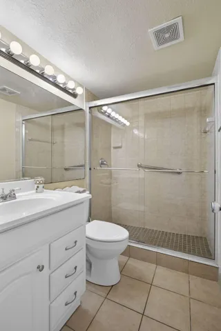 Walk in large shower with slider doors and nice vanity!