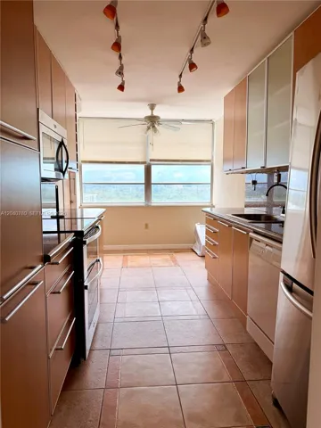 stainless steel appliances and breakfast nook with balcony access.