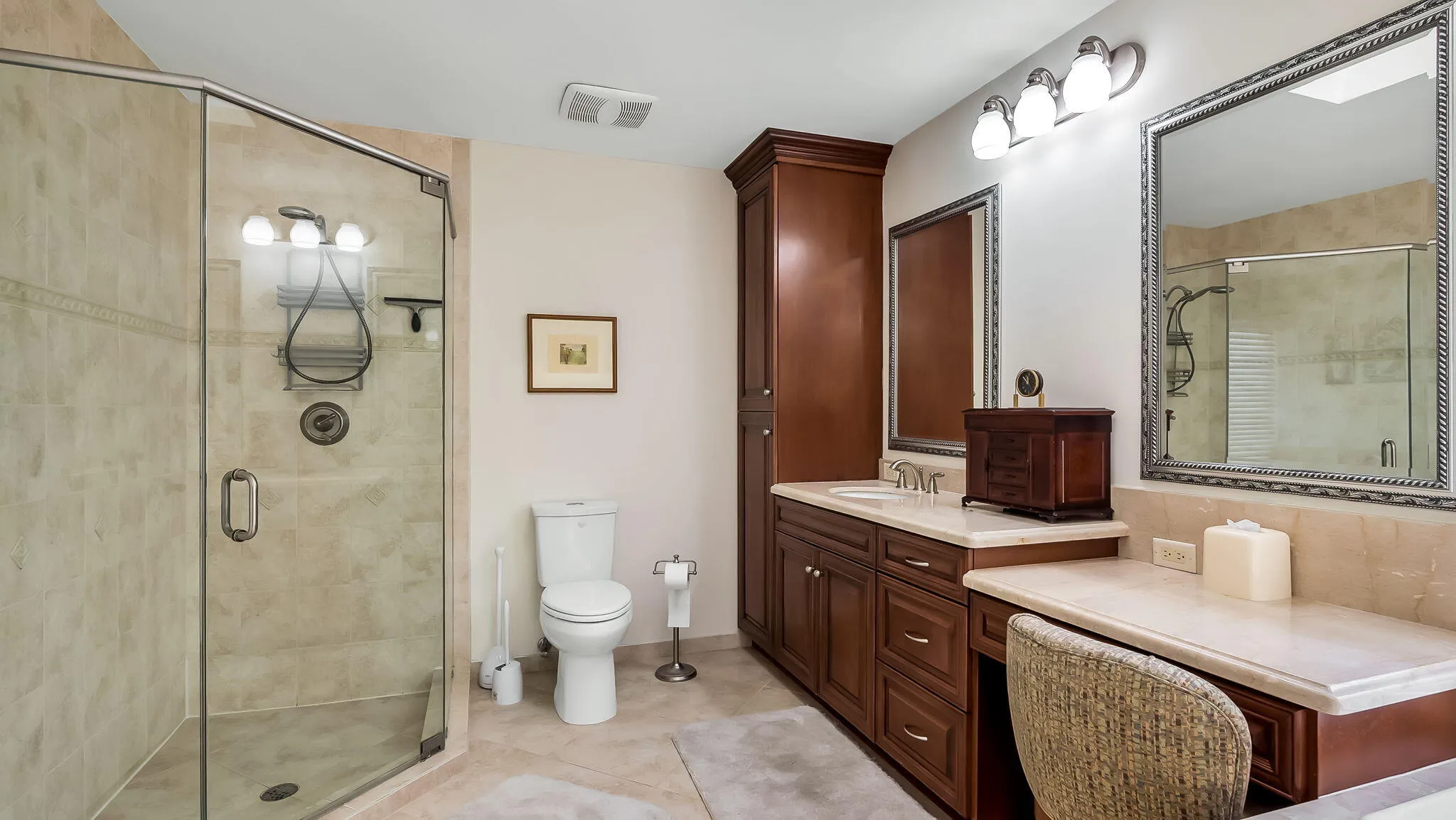 Primary Bathroom with dual sinks and counter seating