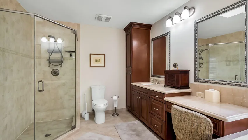 Primary Bathroom with dual sinks and counter seating