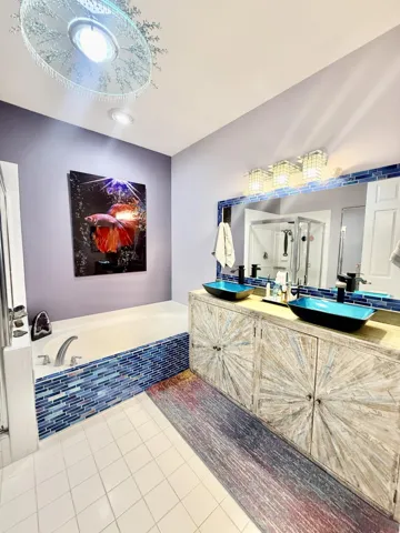 Upgraded Master Bathroom featuring Double Sinks, Large Shower, and Roman Tub
