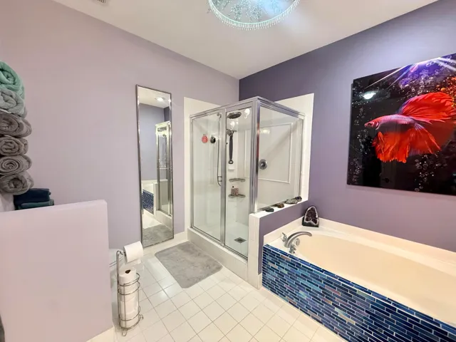 Upgraded Master Bathroom featuring Double Sinks, Large Shower, and Roman Tub