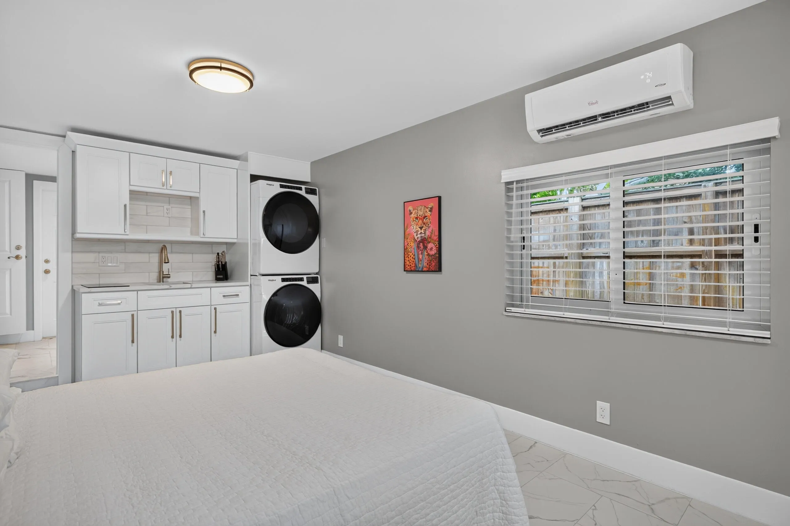 4th Bedroom/Studio that could be perfect for home office, studio rental, craft room, etc...with a small kitchenette, second set of washer/dryer, connected bathroom, mini split AC, and exterior door.