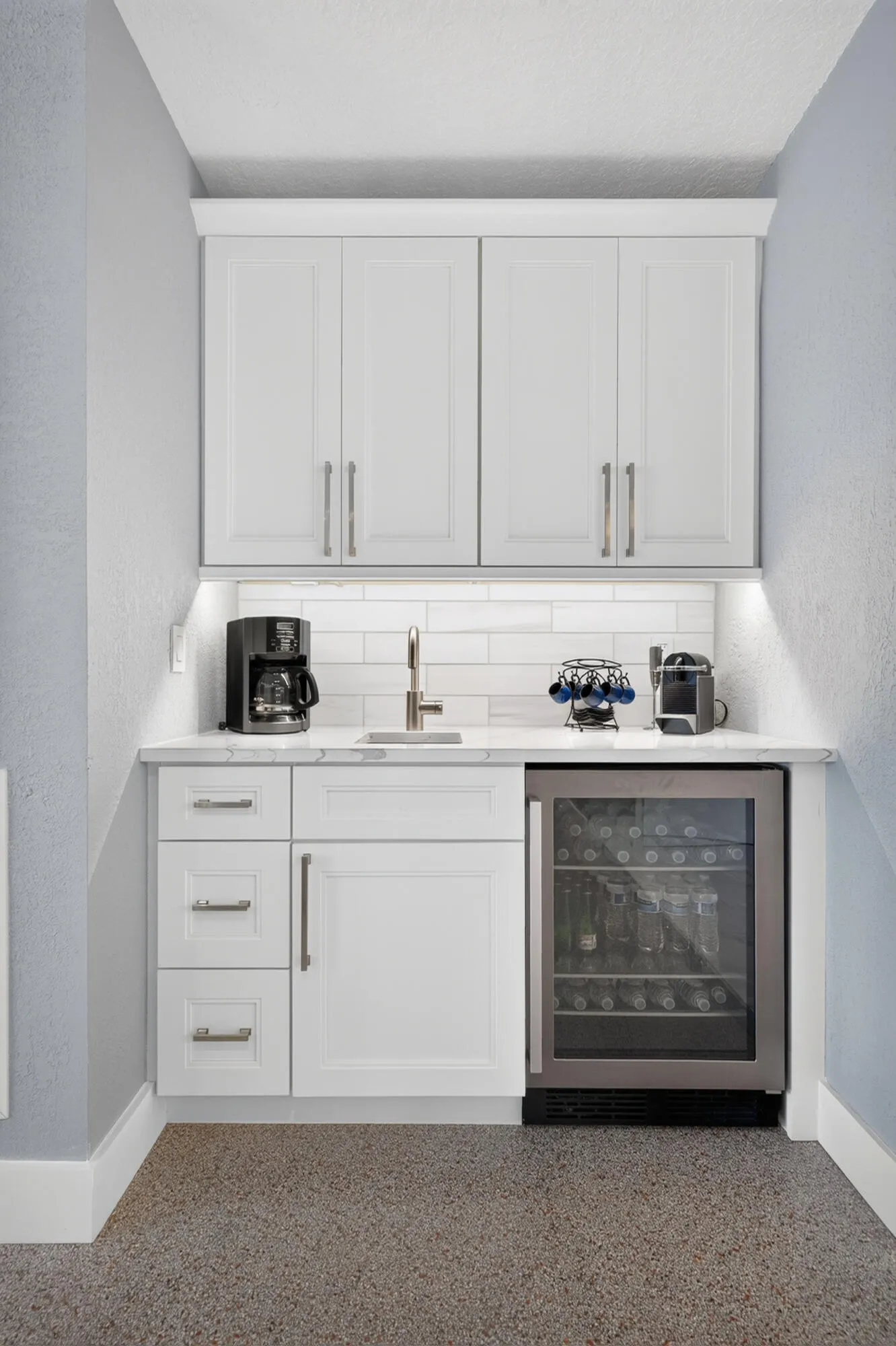 Wet bar located in the living room with beverage refrigerator.