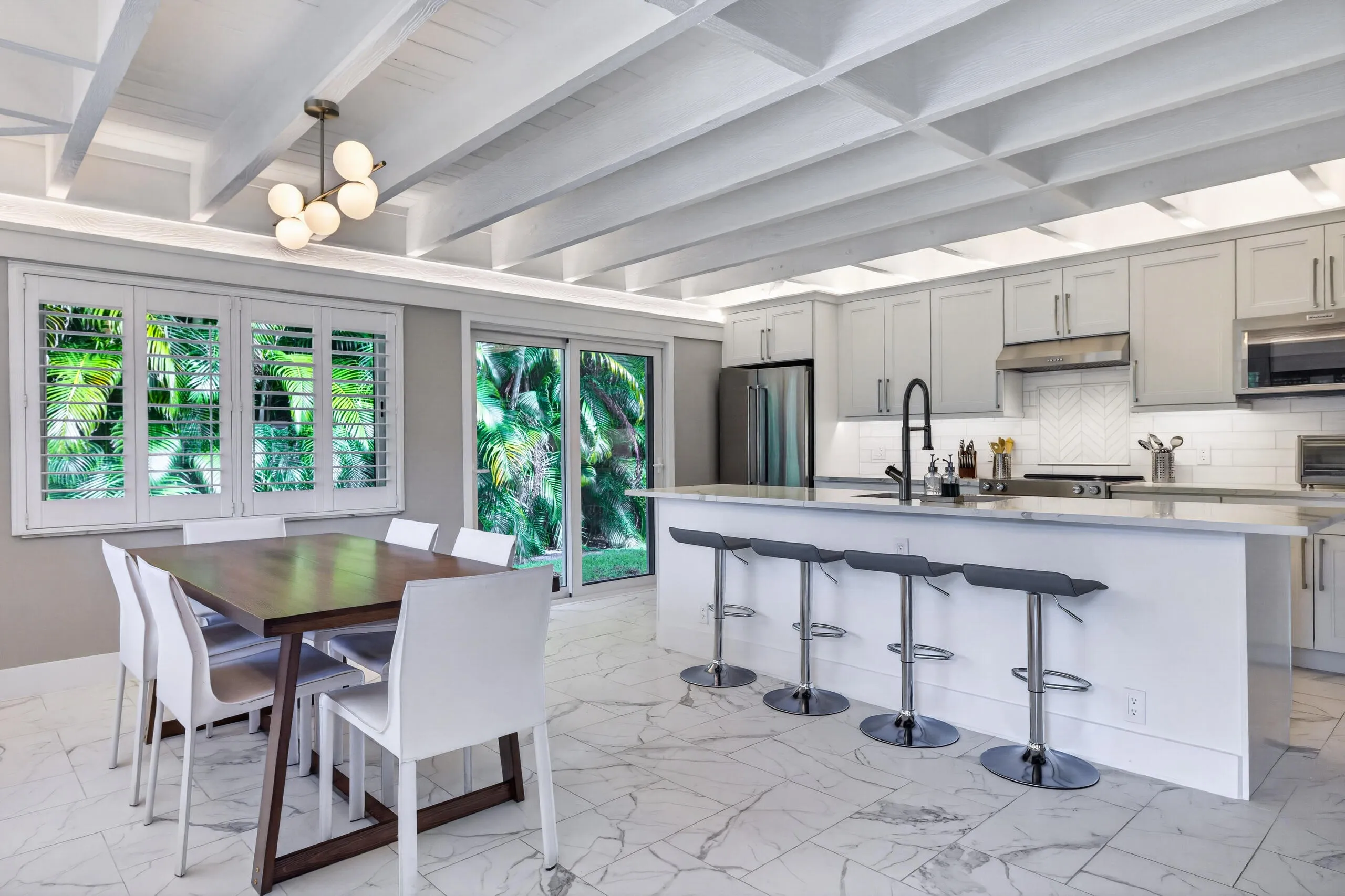 Spacious open kitchen and dining area that looks out over the backyard and patio.
