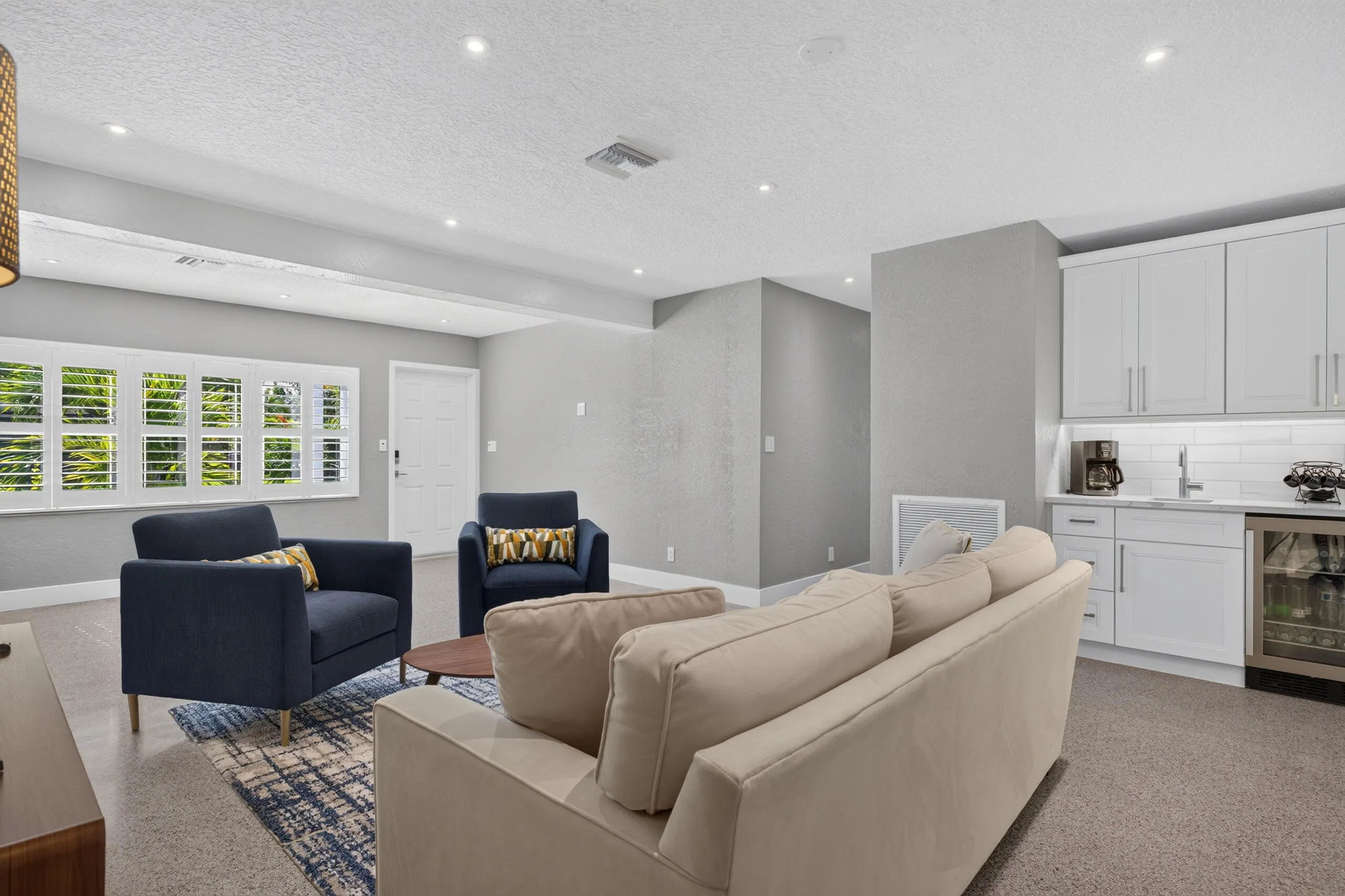 Large living area perfect for entertaining with wet bar with beverage refrigerator.