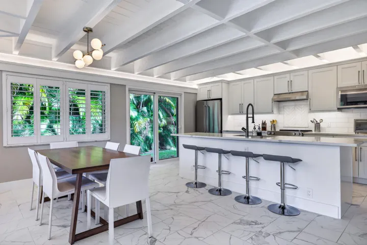 Spacious open kitchen and dining area that looks out over the backyard and patio.