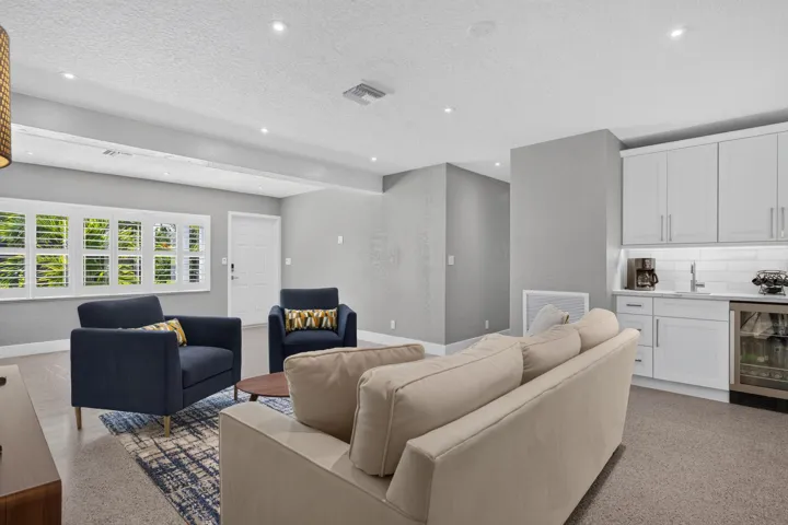 Large living area perfect for entertaining with wet bar with beverage refrigerator.