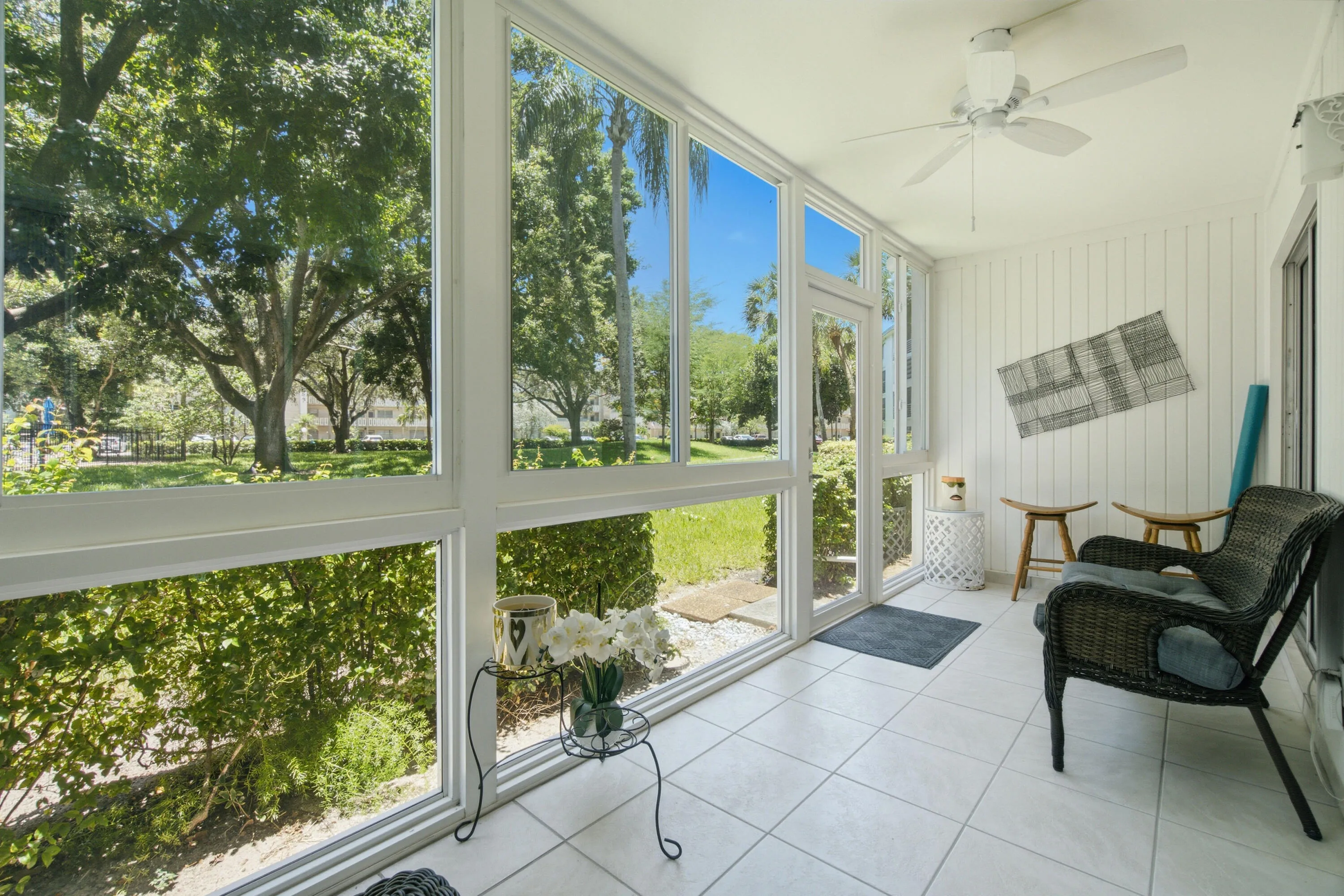 peaceful enclosed patio overlooking pool and trees