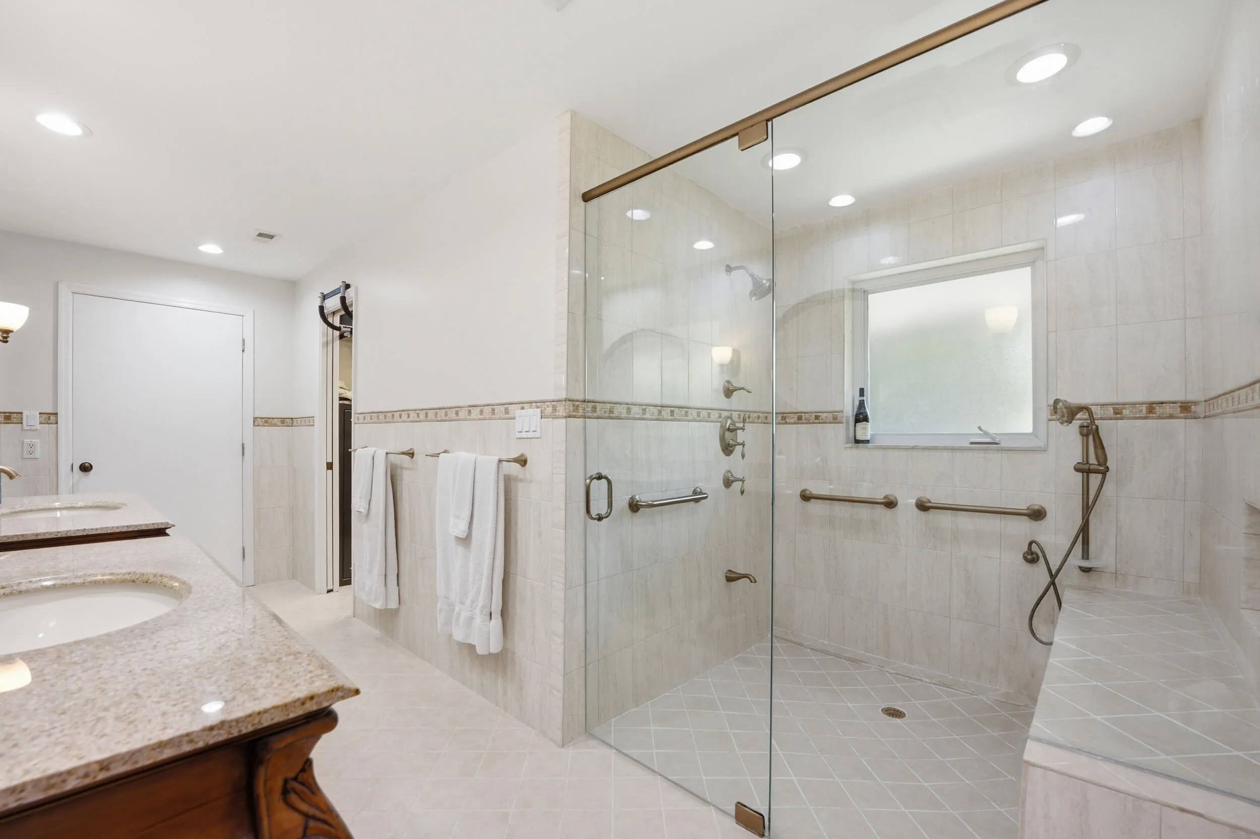 Primary bathroom double shower head glass shower